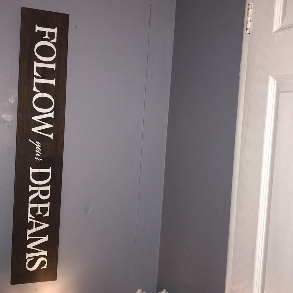 A sign that says follow your dreams